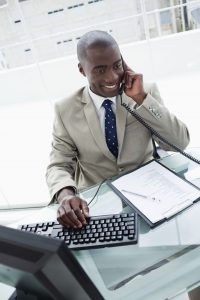 Image of a businessman on the phone in his office for TheWordsFactory's SEO friendly content services.