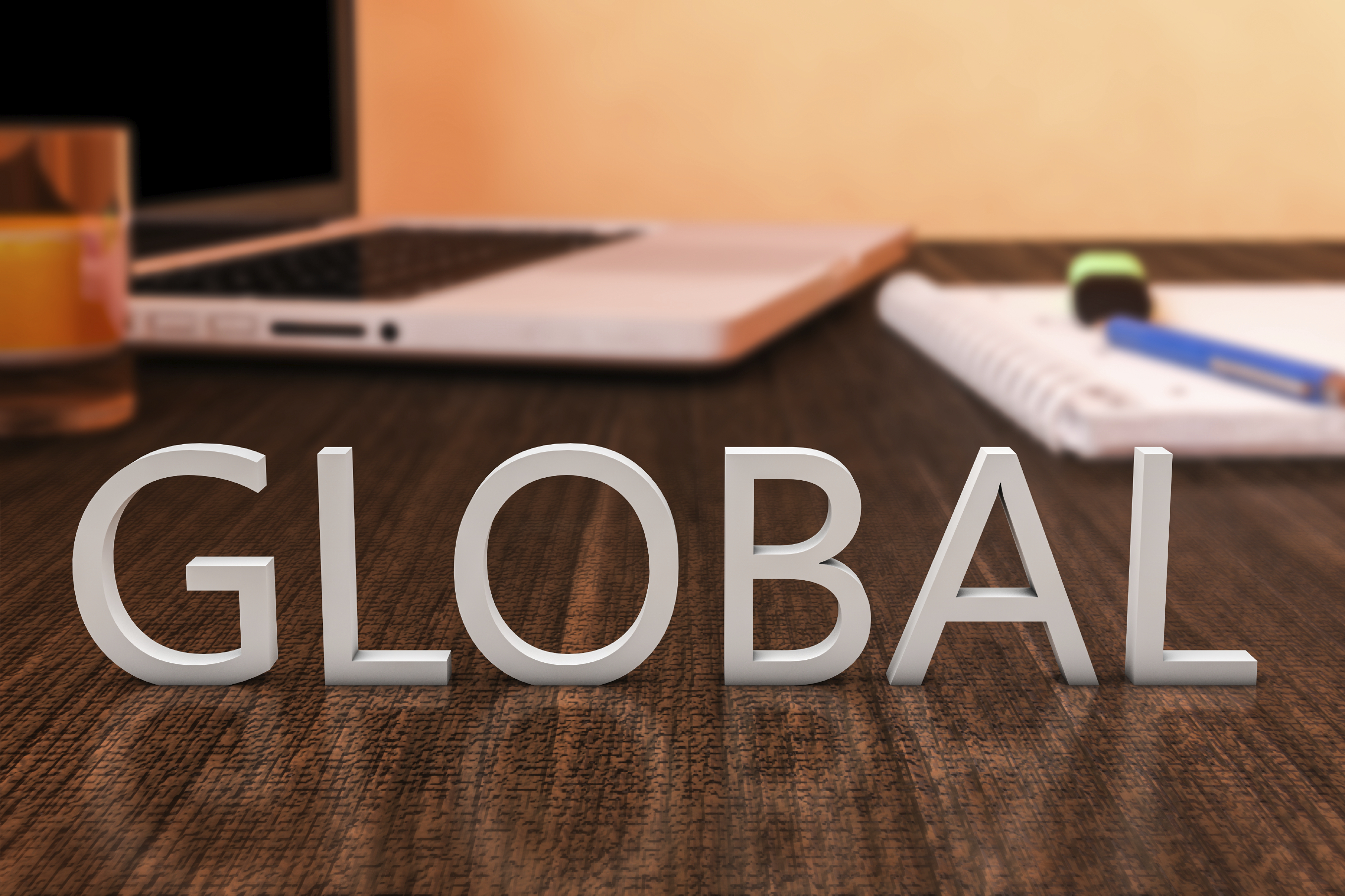 An image of the word global on wooden desk with laptop computer and a notebook for Altwriters Service page.