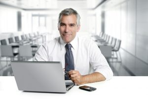 A corporate image of a man in front of a laptop for TheWordsFactory's technical writing page.